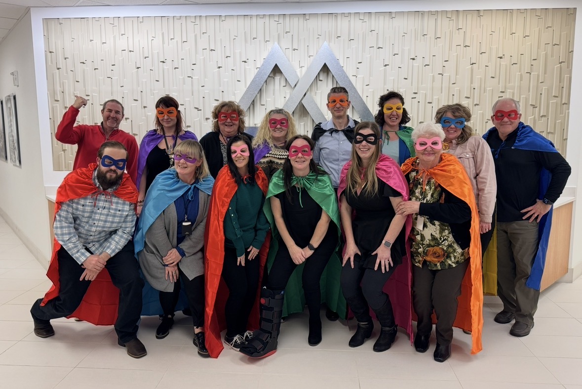 James and his team at a superhero-themed team-building event